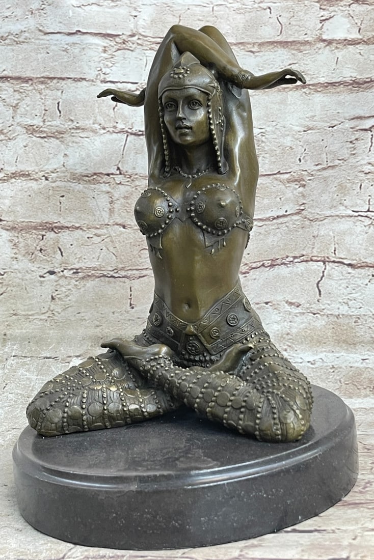 Lady Yoga Meditation Bronze Sculpture: The lovely dancer in a remarkably decorated costume sits Indian style with her arms bending behind her head in synchronicity. She sits harnessing the necessary passion for her performance while she st