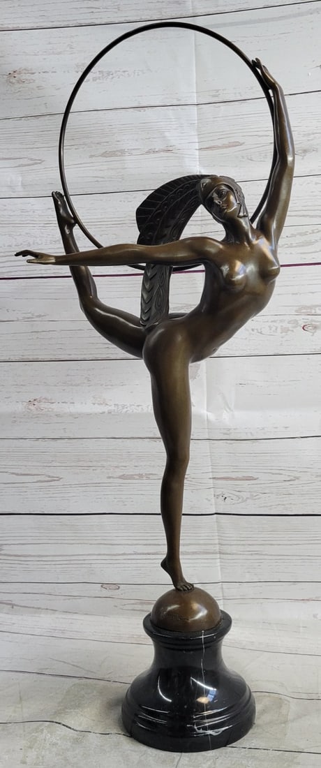 Morante Hoop Dancer Bronze Sculpture: With ease, she extends her back leg out and her arm out to her side while balancing on one foot. She holds a hoop with her lifted a foot and her hand, she performs her dance with ease and confidence l