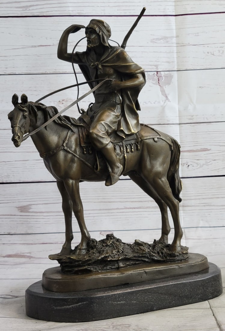 Morrocan Arab Man on Horse Hunter Statue: This Sculpture features a man in traditional Arabian garb riding a horse through the desert searching for an oasis. He holds his hand up to shield the torturous sun as his eyes lose and find something