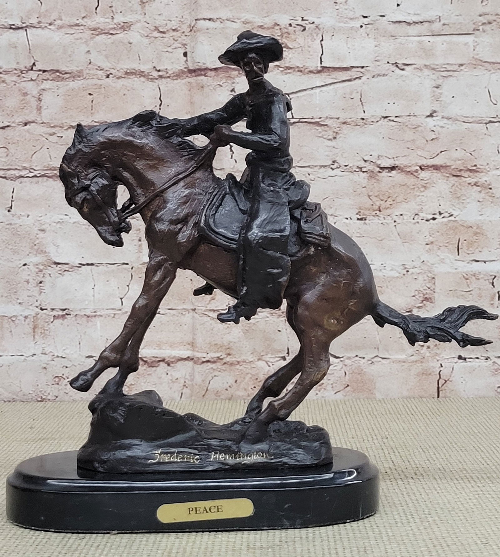 Cowboy and his Horse Bronze Figurine: A cowboy charges across the dry land with his gun in the air. His horse gallops, with its nose, pointed forward. The cowboy holds the reins tightly in his free hand and he squeezes his thighs on each