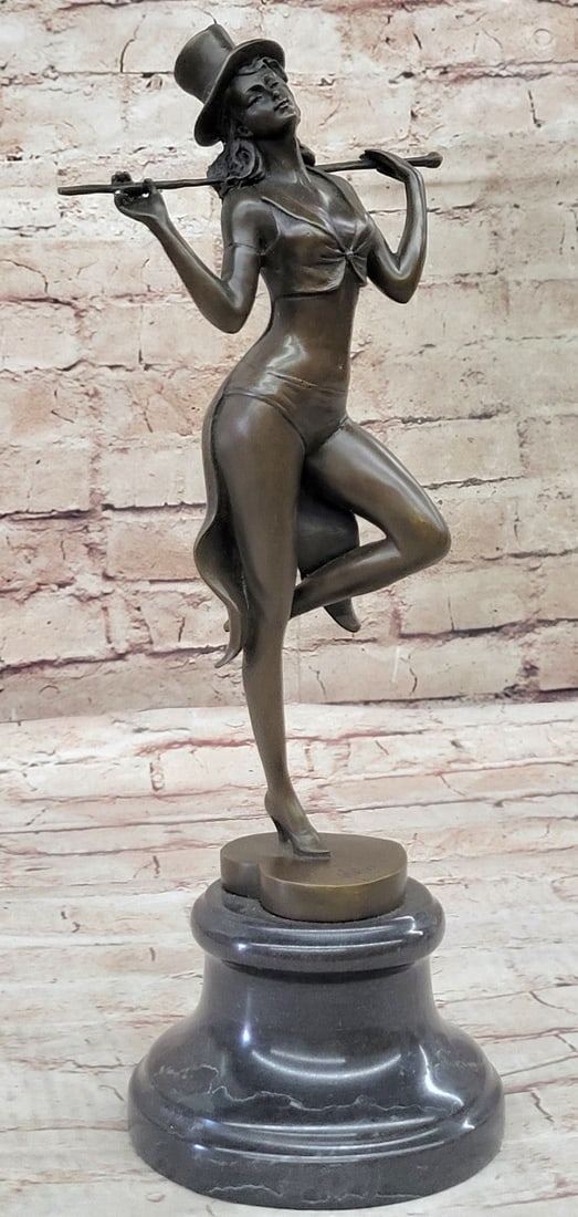 Dancer Bronze Sculpture: The red velvet curtain has just opened as the single spotlight shoots on the jazz dancer holding her pose before starting her lively act. She rests all her weight on her left leg as she bends her righ