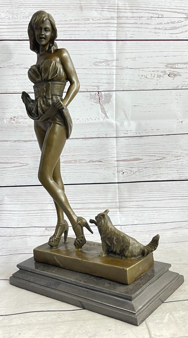 Alluring Woman with Cat Bronze Sculpture: This sculpture combines a sense of playfulness and sexiness. The alluring woman, upon returning home, begins to disrobe as her cat playfully greets her at her feet. Both of her hands are suspended by