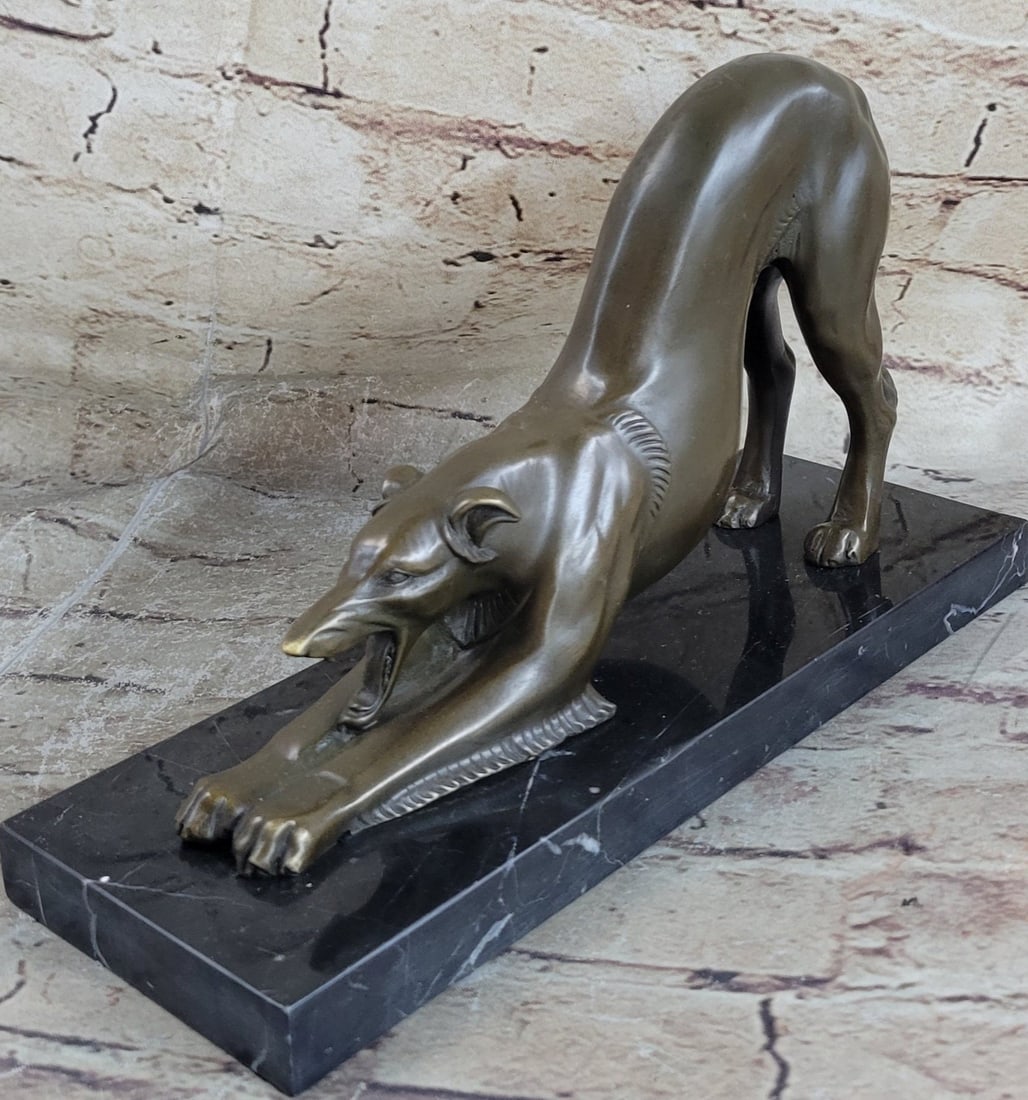 Greyhound Racing Dog Bronze Sculpture: Hunched in down this cute Greyhound reveals a low feral growl. His mouth gapes open bearing his sharp teeth to his prey, instilling anticipation and fear. The dog flexible lean body is beneficial in h