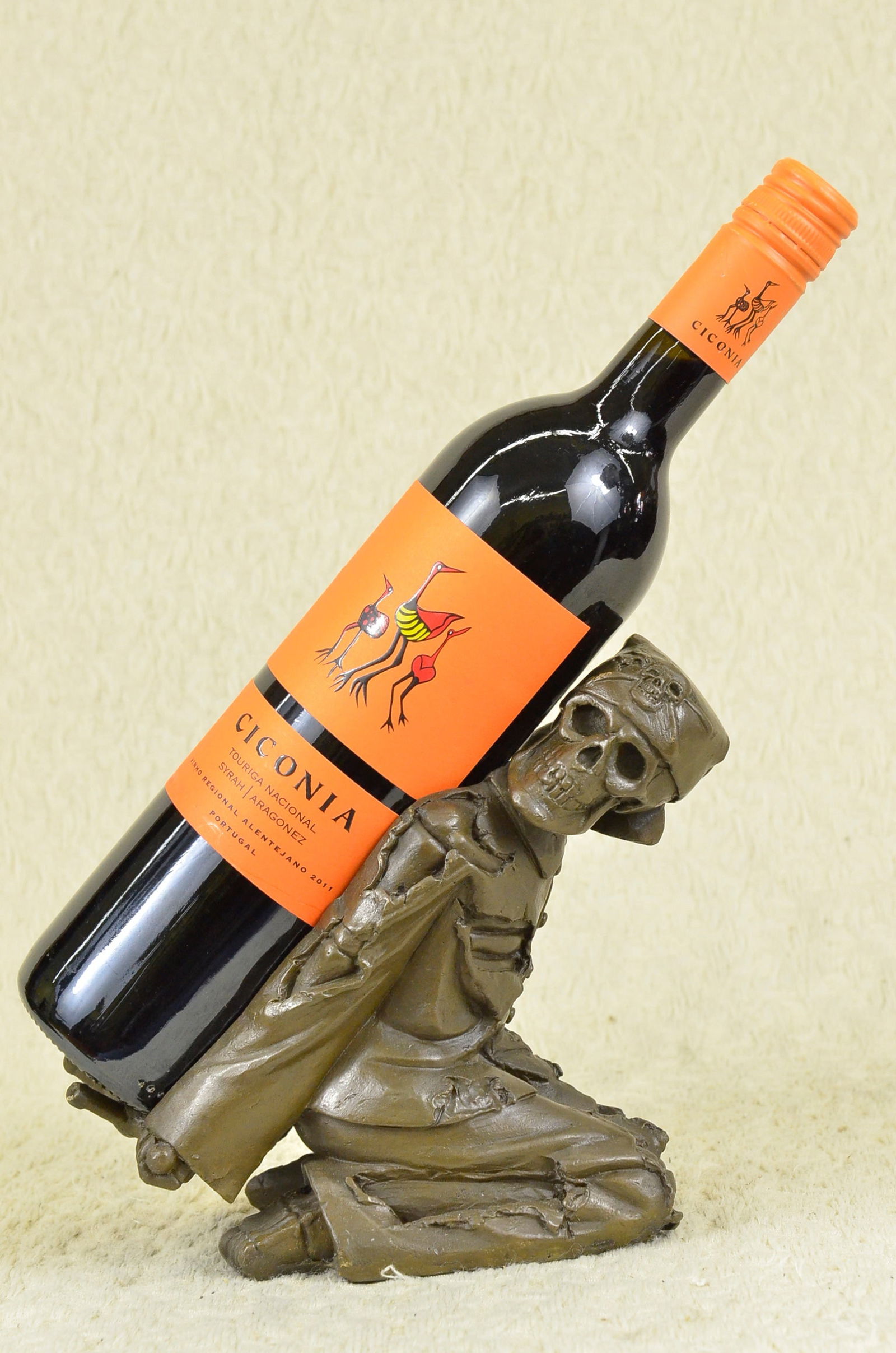 Skeleton Wine Holder Bronze Sculpture: This ghastly, grinning human skeleton bottle holder is great for holding wine bottles, liquor bottles, or for holding olive oil as part of your kitchen decor. Made of real bronze, the holder stands 6