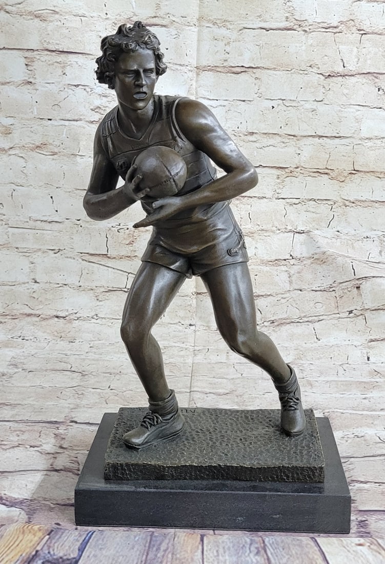 Rugby Football Player Bronze Sculpture on Marble Base Statue: A muscular Rugby player runs for the end field, trying to skip the yards and avoid being tackled. His powerful legs ache as he sprints and dodges. He Kicked the ball under him protectively. Every once