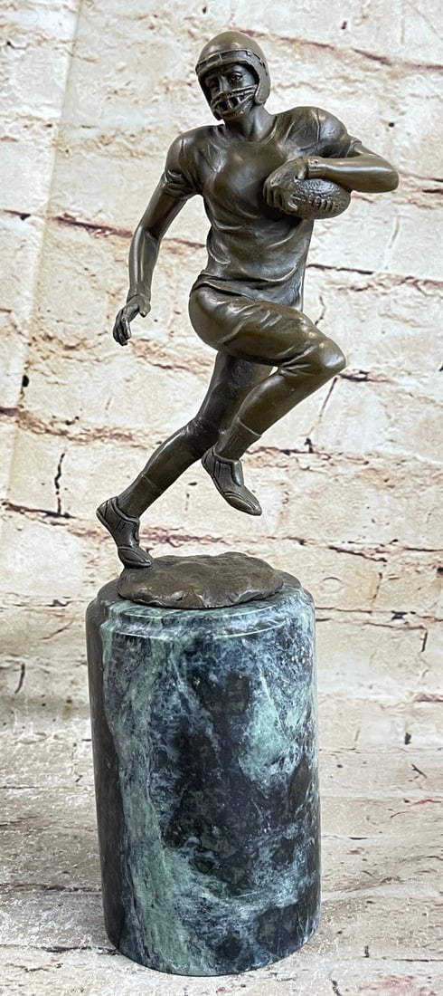 Football Player Bronze Sculpture: A muscular football player runs for the end field, trying to skip the yards and avoid being tackled. His powerful legs ache as he sprints and dodges. He tucks the ball under his arm protectively. Ever