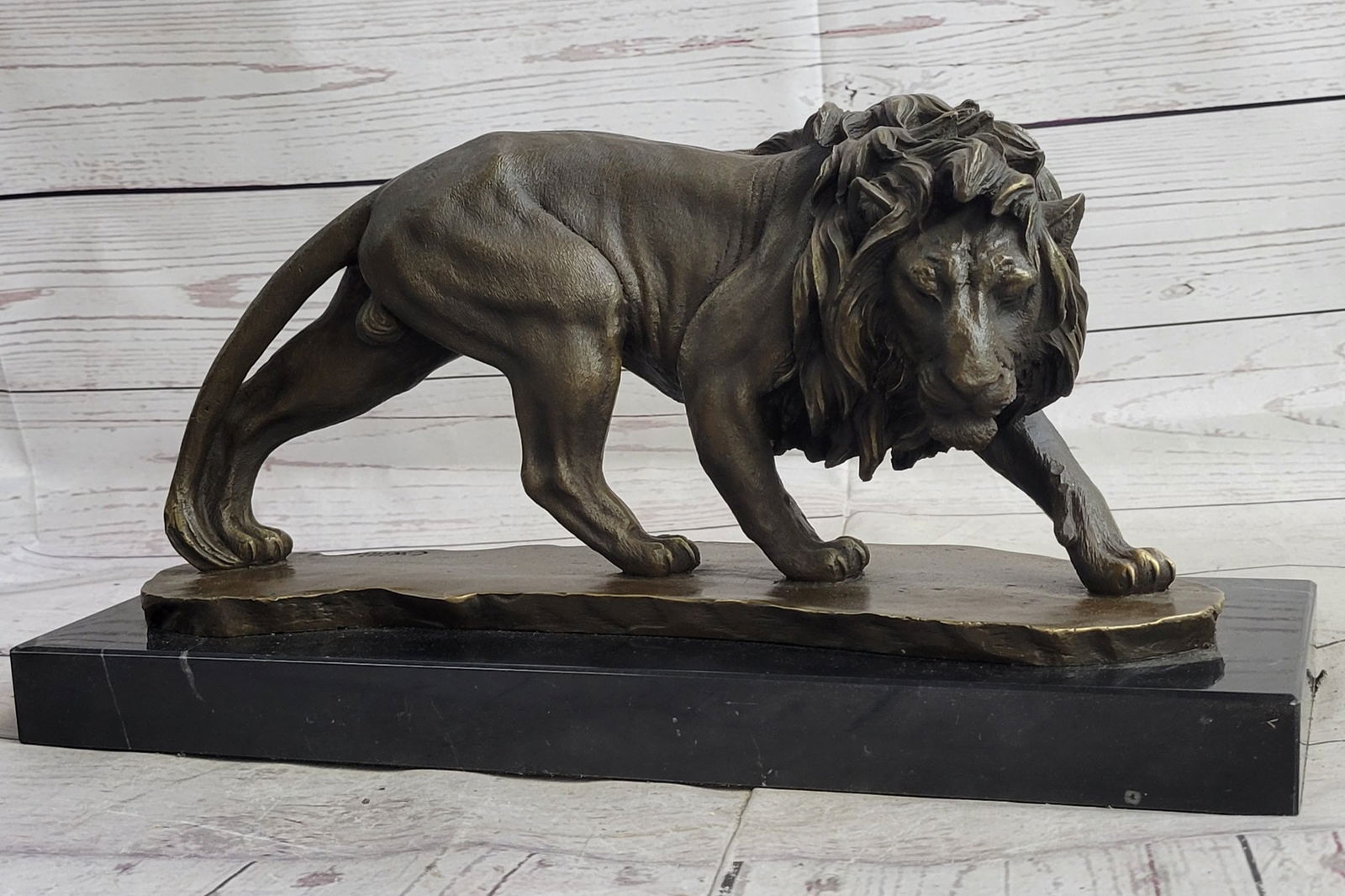 Wildlife Male Lion Bronze Sculpture: Though the most feared and lethal predator of the jungle, the beauty of a lion is undeniable. This bronze sculpture includes the smallest details of the king of all wild cats, including the stretch of