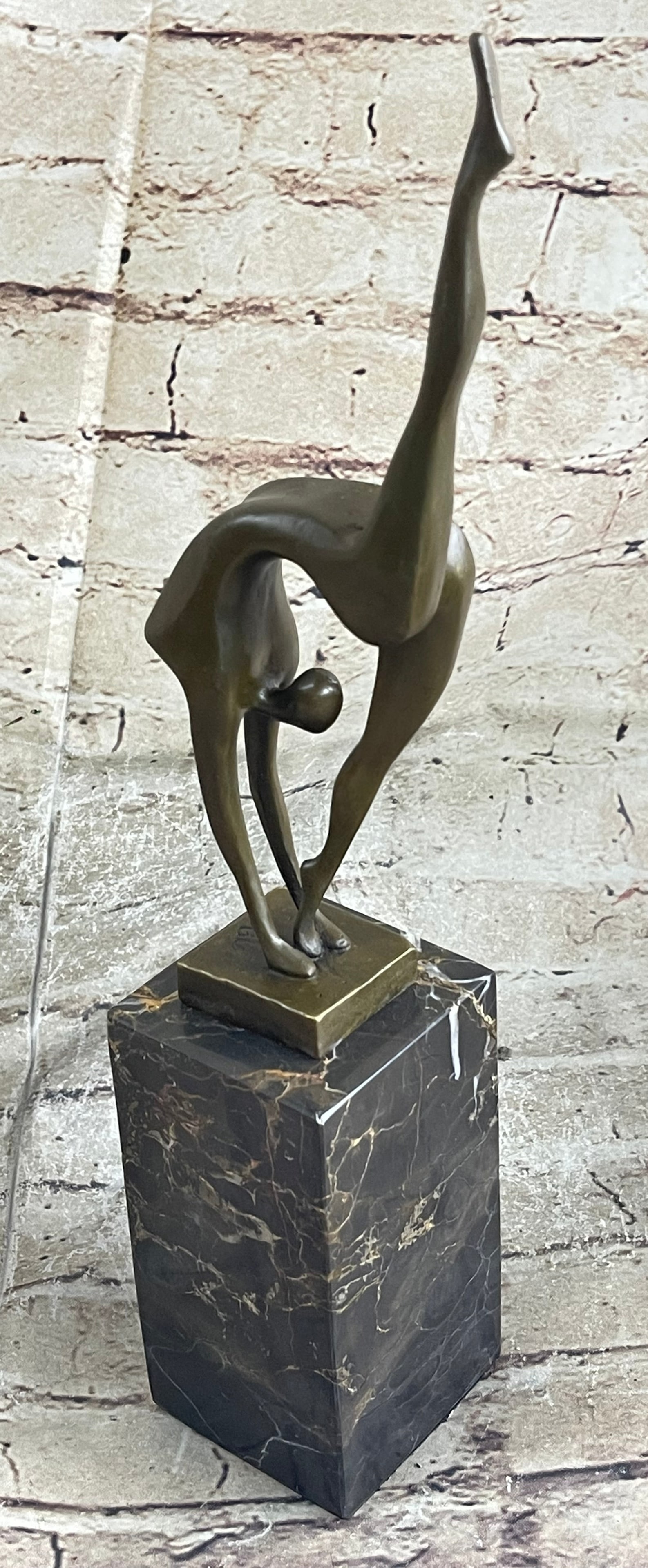 Ballerina Bronze Figure: With grace, agility, and flexibility, this abstract gymnast competes for gold. Her body moves fluidly as she curves backward and touches the mat. Though her body is slender, she packs a lot of energy