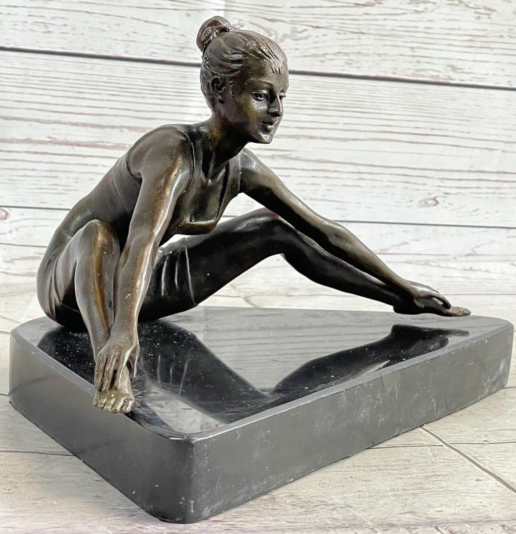 Female Gymnast Bronze Sculpture: This beautiful sculpture of a young girl posing and stretching at the same time is gorgeous and would go perfect in your athletic daughter's room or for a friend who likes to work out a lot. She is si