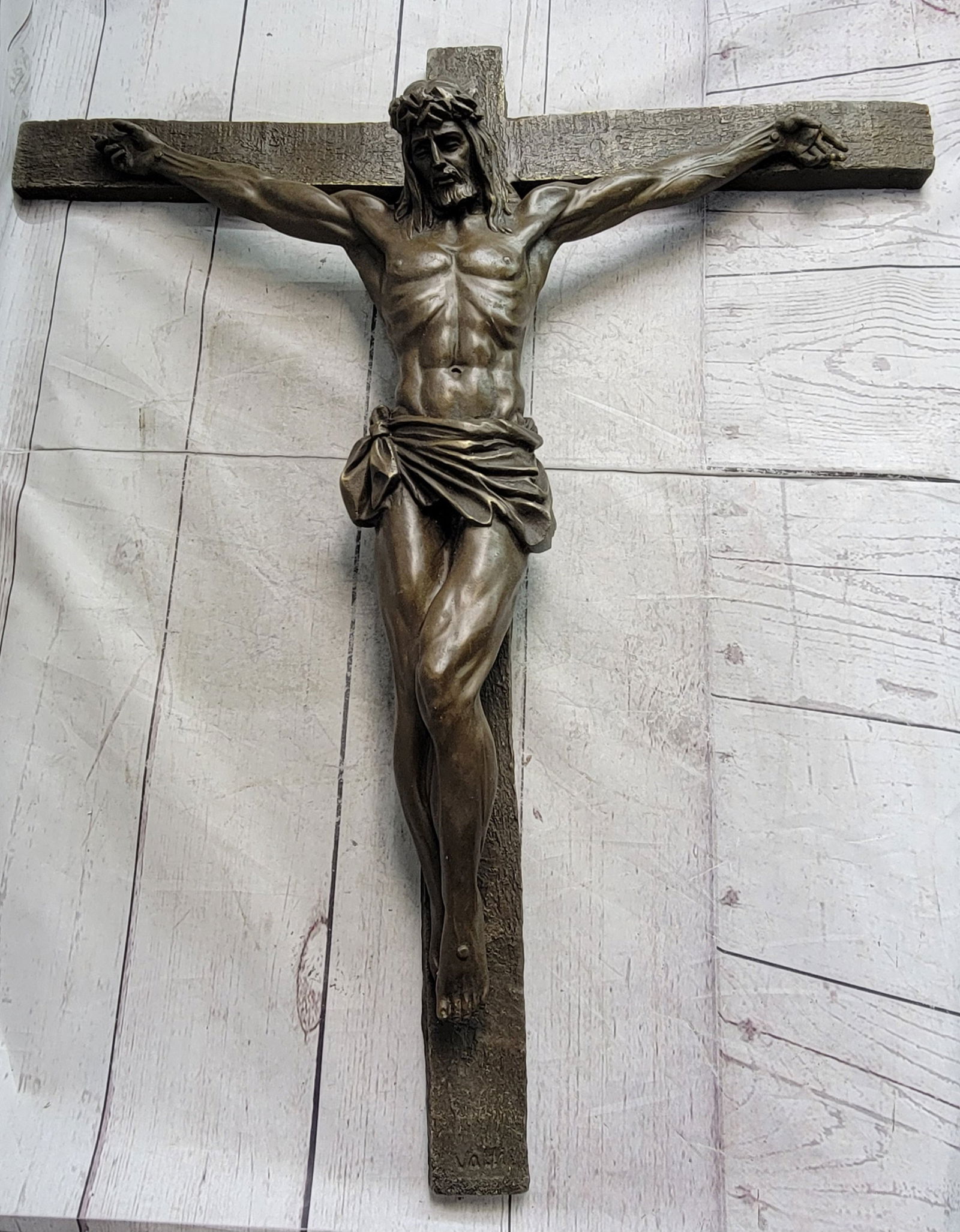 Jesus Crucifixion Bronze Sculpture: Christ, hanging below a sign proclaiming INRI, or King of the Jews, is depicted on the cross where he gave his life as restitution for all who believe, repent and call on His name. This artist symbol