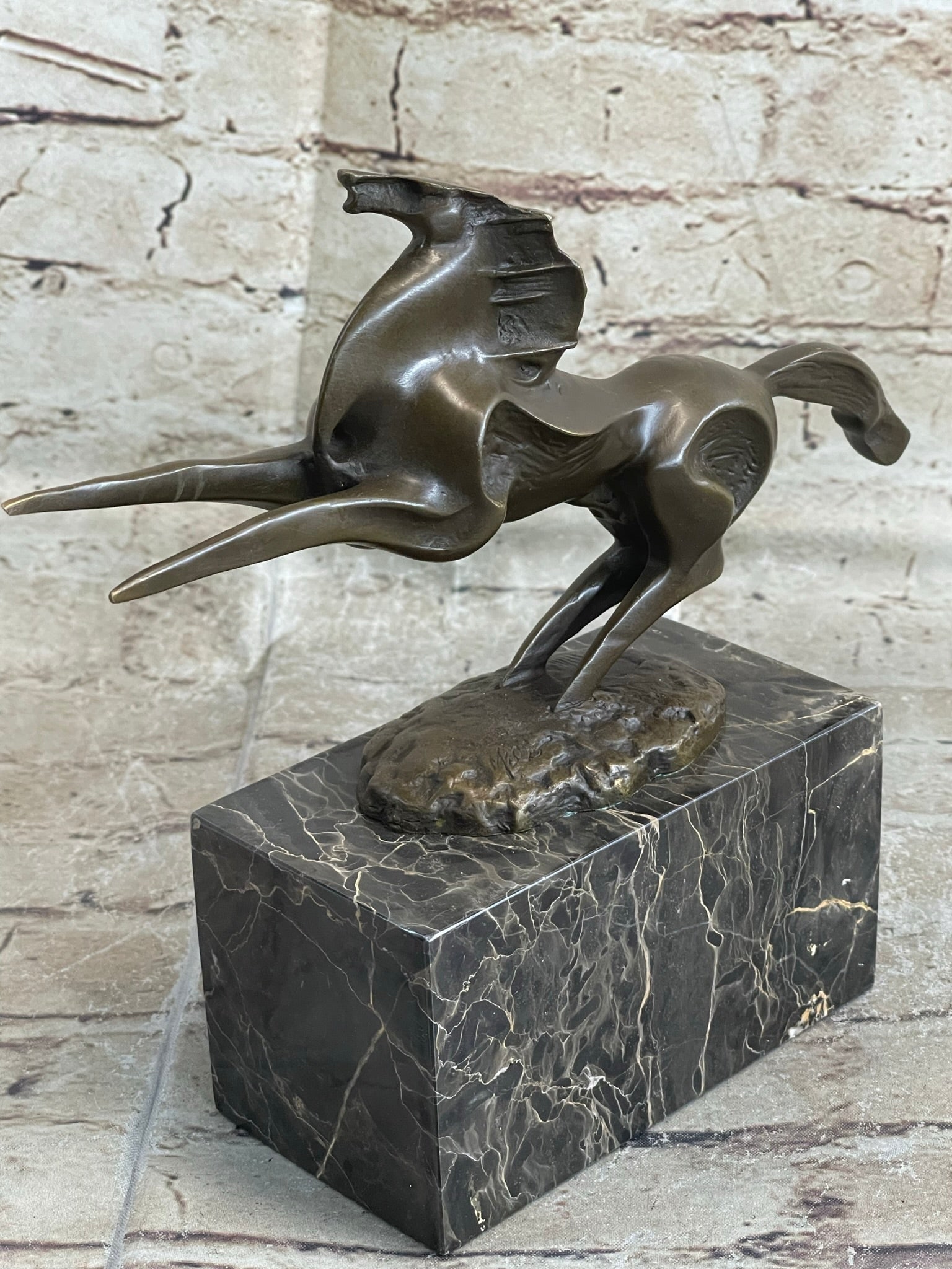 Horse Stallion Bronze Sculpture: This abstract and modern horse gallops into the wind and rears up letting out a wild neigh as the wind seems to push against him with a mighty force. This abstract horse captures emotions from the art