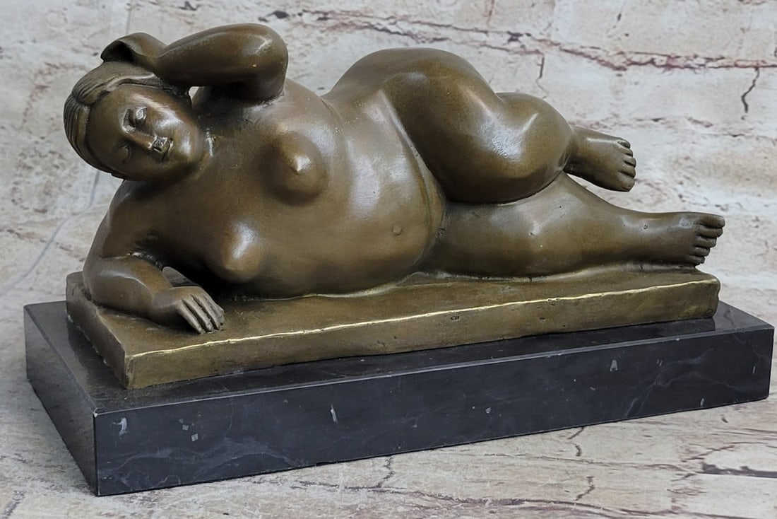 Classic Female Bronze Sculpture on Marble Base Statue: The woman is proportionally exaggerated, giving a defined plumpness to every part of her form. The pleasantly full-figured lady lays on her side both calm and relaxed. A sense of peace and happiness r