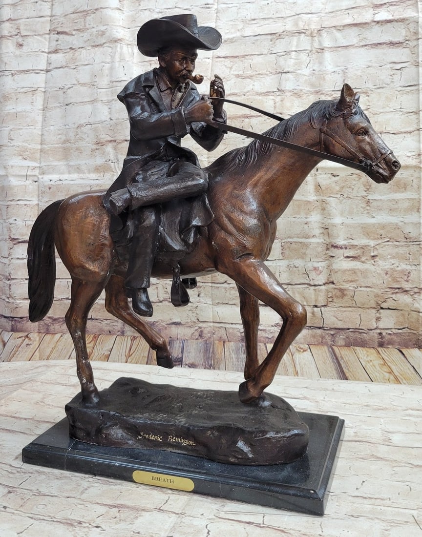 Cowboy Bronze Sculpture: Patinated western bronze sculpture, Breath, marked J. Theodore, depiction of a cowboy sitting side-saddle on his horse and lighting his pipe, on a black marble base. This bronze sculpture was molded u