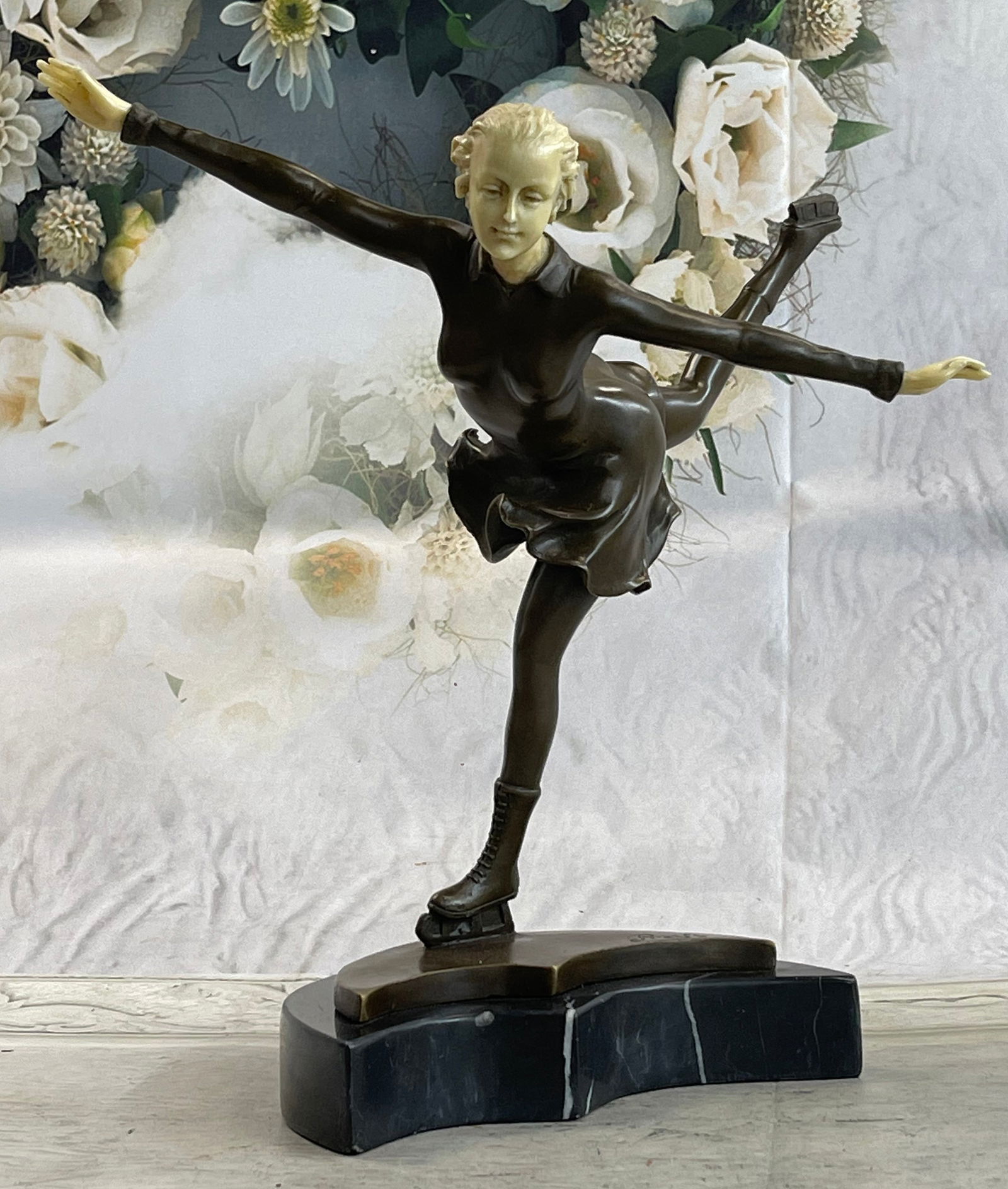 Ice Skater Sport Arena Sculpture Statue: A lovely lady puts on a show. Well trained in the art that she loves, she shows off her agility, balance, and flexibility. She elevates her long lean leg far behind her. Her fingertips graze her calf