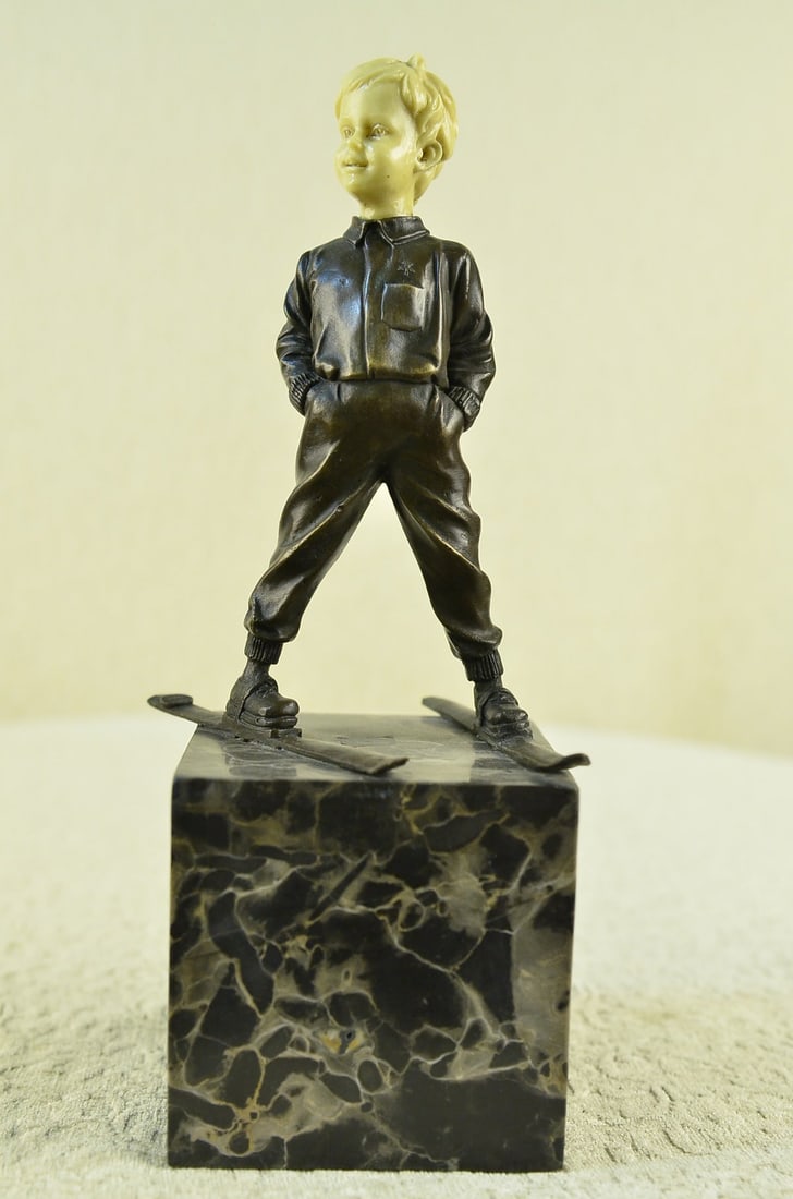 Little Boy Standing on Skies Bronze Figurine: This little boy is standing in the skies and looks just adorable with his hands in his pocket as he looks to his right. He looks like a little grown-up in his stance, sort of makes you wonder what he