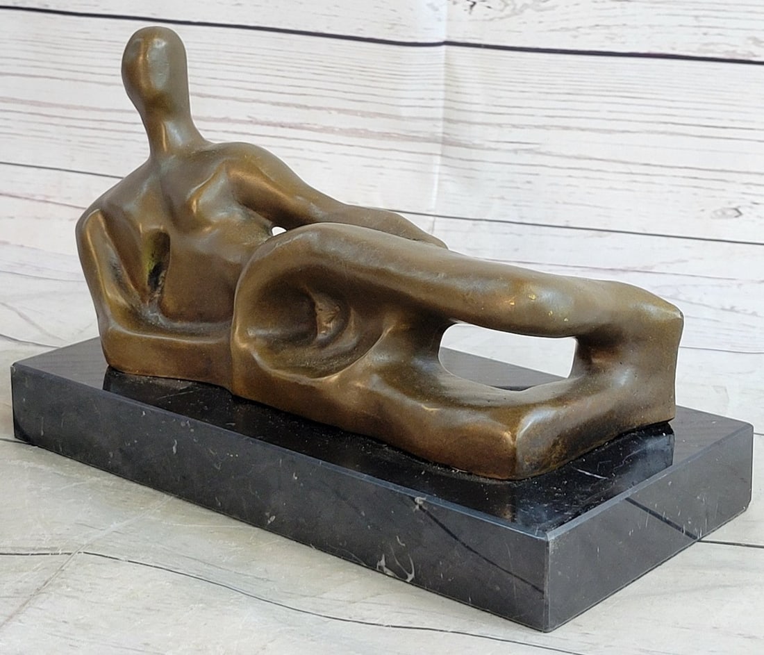 Nude Female Bronze Statue: Abstract and representational style, the woman is proportionally exaggerated, giving defined plumpness to every part of her form. The pleasantly full-figured lady lays on the ground both calm and rela