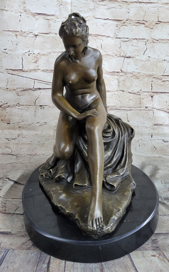 A Nude Maiden Bronze Figure: This a beautiful, Bronze figure captivated Diderot and his contemporaries. Instead of sculpting the idealized body of a goddess, Allegrain shows a woman in all her mortal realism. The fluidity of the