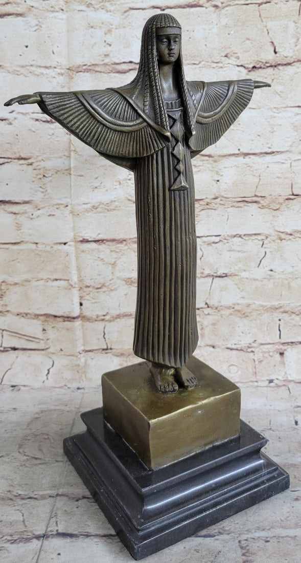 Egyptian Princess Bronze Statue: This is a beautiful Sculpture of an Egyptian woman dancer. Her feet and legs placed together and her arms stretched out and she has on an intricately elaborated head garment. She stand still and strai