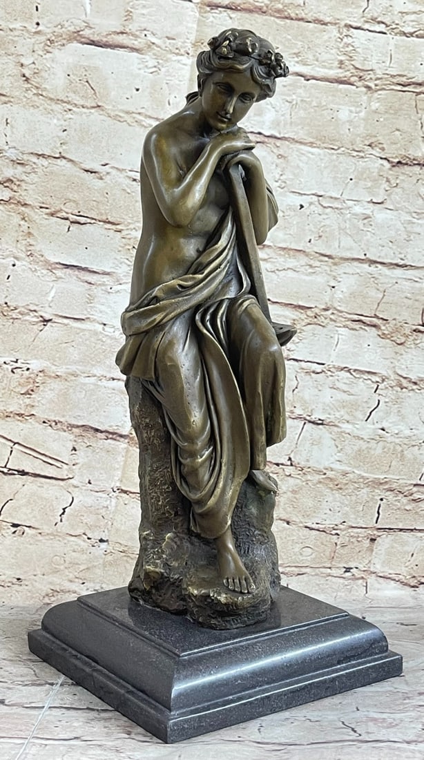 Nude Lovely woman Resting Bronze Sculpture: The lovely woman rests seated with her chin on her hands. She gazes towards the ground in a happy dreamy state. Her beauty is a natural, a calm simple beauty. Her wavy hair is styled down her back. A