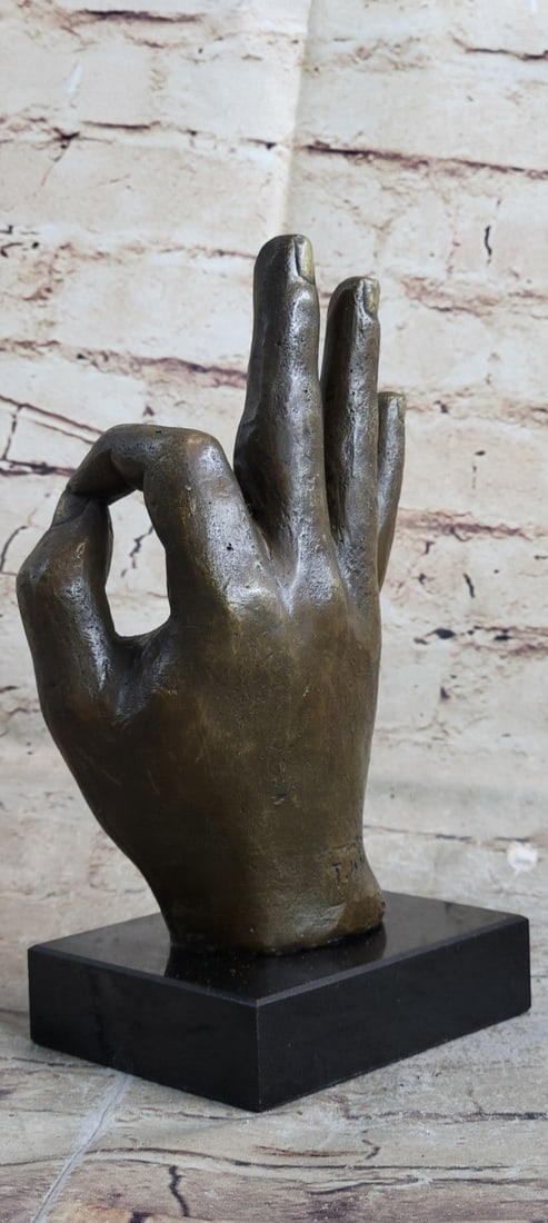 OK Gesture Bronze Sculpture: Gestures are the most direct body signals given while interacting with someone. These include the movement of the head (a tilt or nod), any noticeable shoulder movement (a shrug or lean in), hand move