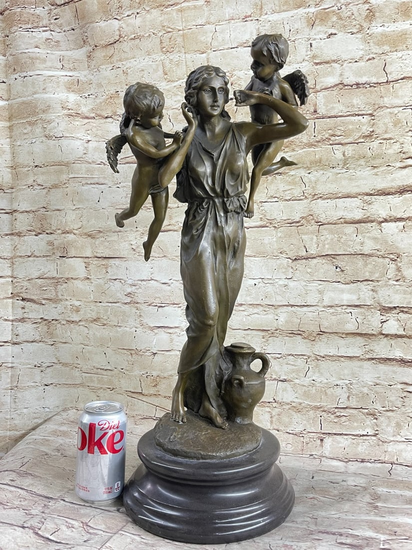 Mother's Day Cherub Angel Bronze Statue: This delightful piece depicts a woman standing by a water jug with two cherubs flying by her head. She holds her hands up to her ears As each cherub looks to her as if they are about to say something.