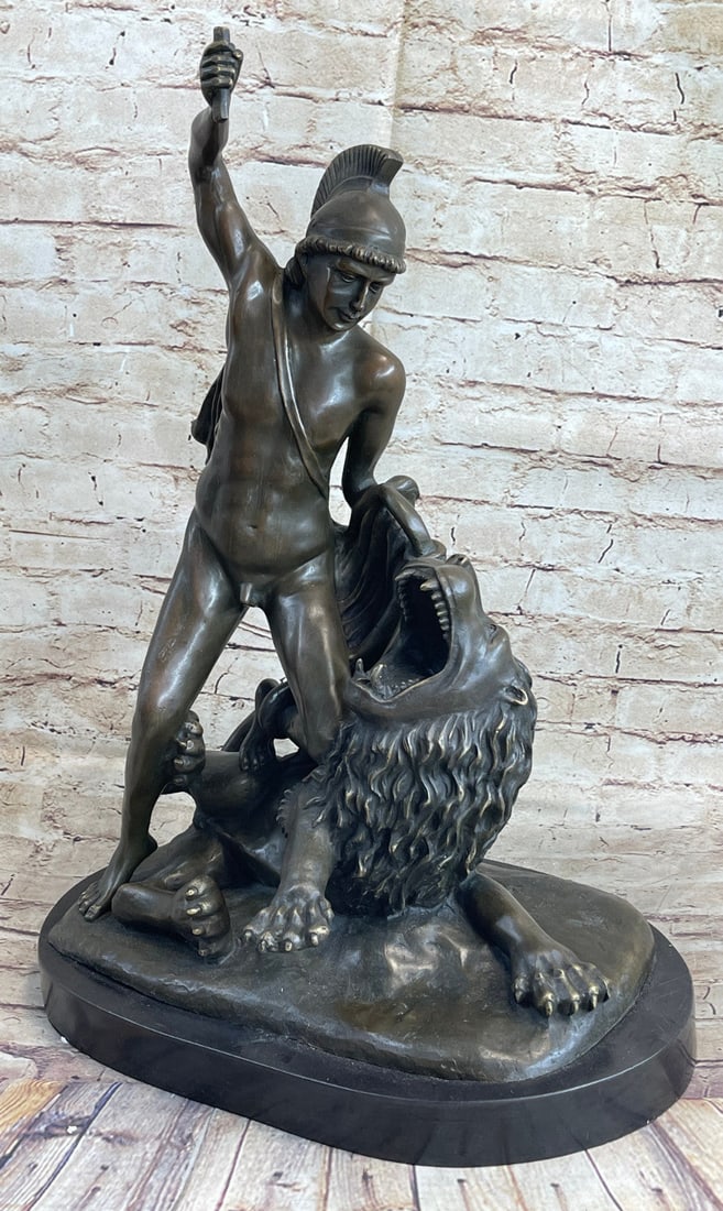 Roman Warrior Beast Lion Bronze Sculpture: A brave warrior leans into a savage beast preparing to slay it. He raises his right hand with his weapon grasped right in it. The fighter is wearing Roman head gear but otherwise is completely nude gi