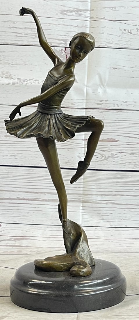 Prima Ballerina Dancer Bronze Sculpture: This lovely young ballerina stands on one leg balancing her weight on it as if it's nothing. She is a delight to watch young yet very talented and strong. She has this graceful look to her face even i