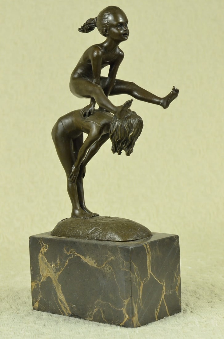 Kids Playing Leap Frog Bronze Sculpture: This sculpture represents pure youth and innocence between children. Two young siblings spend the afternoon playing. They are eternal companions. One bends low and allows the other to leap over her ba