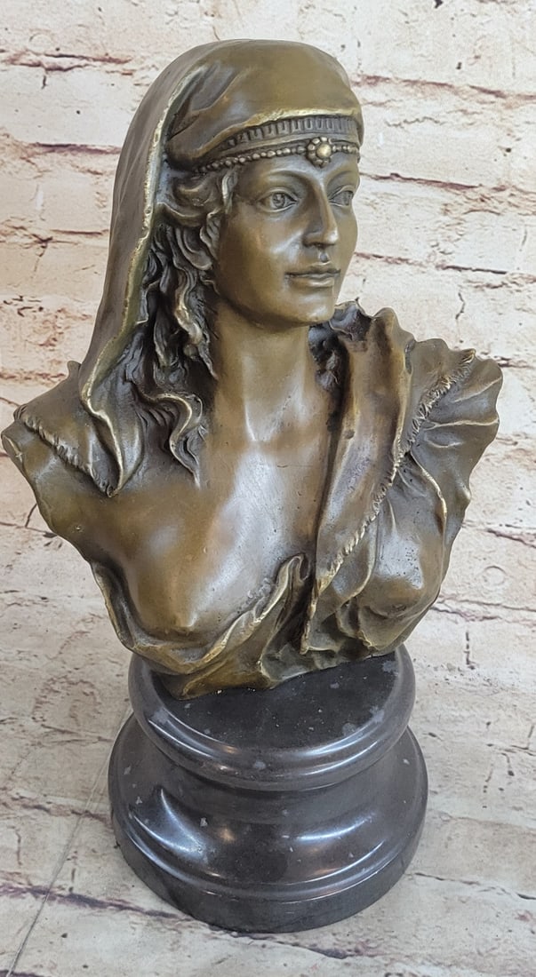Maiden Semi Nude Bust Bronze Sculpture: The beautiful maiden bust shows, upon her delicate face, the subtlety of expression that transfers a great deal of emotionalism and realism. Her head falls in a sullen silence amidst the spinning of t