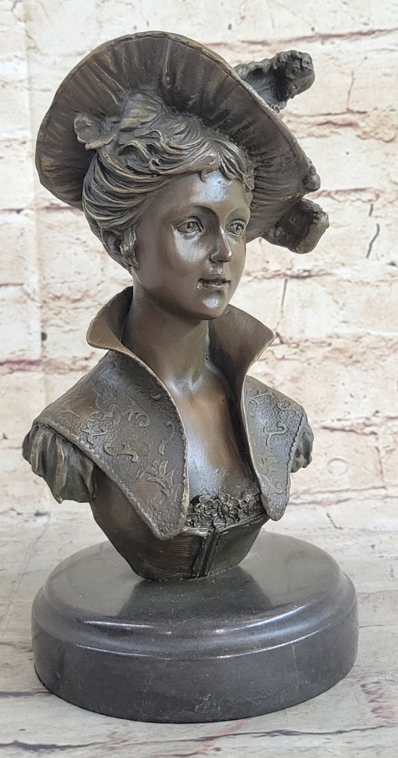 Girl Bust Lady Bronze Sculpture: This piece is the epitome of refinement and is a bust Statue of an elegant girl in a feathered dress hat. She is no doubt a woman of high standing going out for a royal day in town. She wears an intri