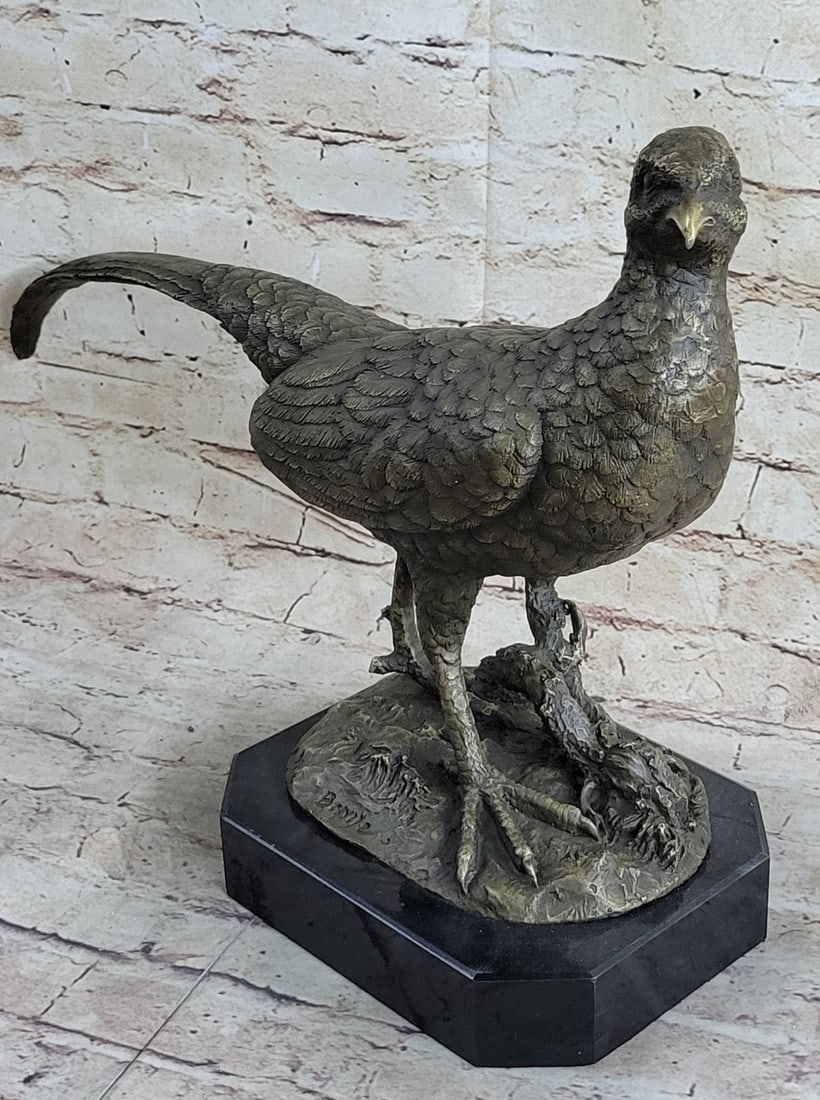 Wildlife Trophy Bird Hunter Bronze Statue: The pheasant is captured in a slowed down moment of action. Startled, the extravagant male, leans forward on it is perch, letting out a cry of surprise. His beautiful and long tail shoots vertically u