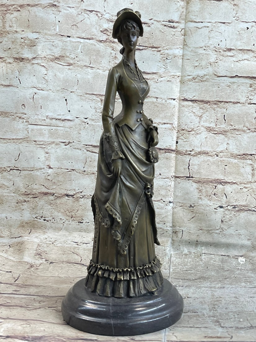 Victorian Lady With Flowers Bronze Sculpture: This bronze sculpture of a 1920`s woman with four feathers in her right hand standing proudly for the silent era. Her unforgettable dress that drops all the way to the floor from the back, while the f