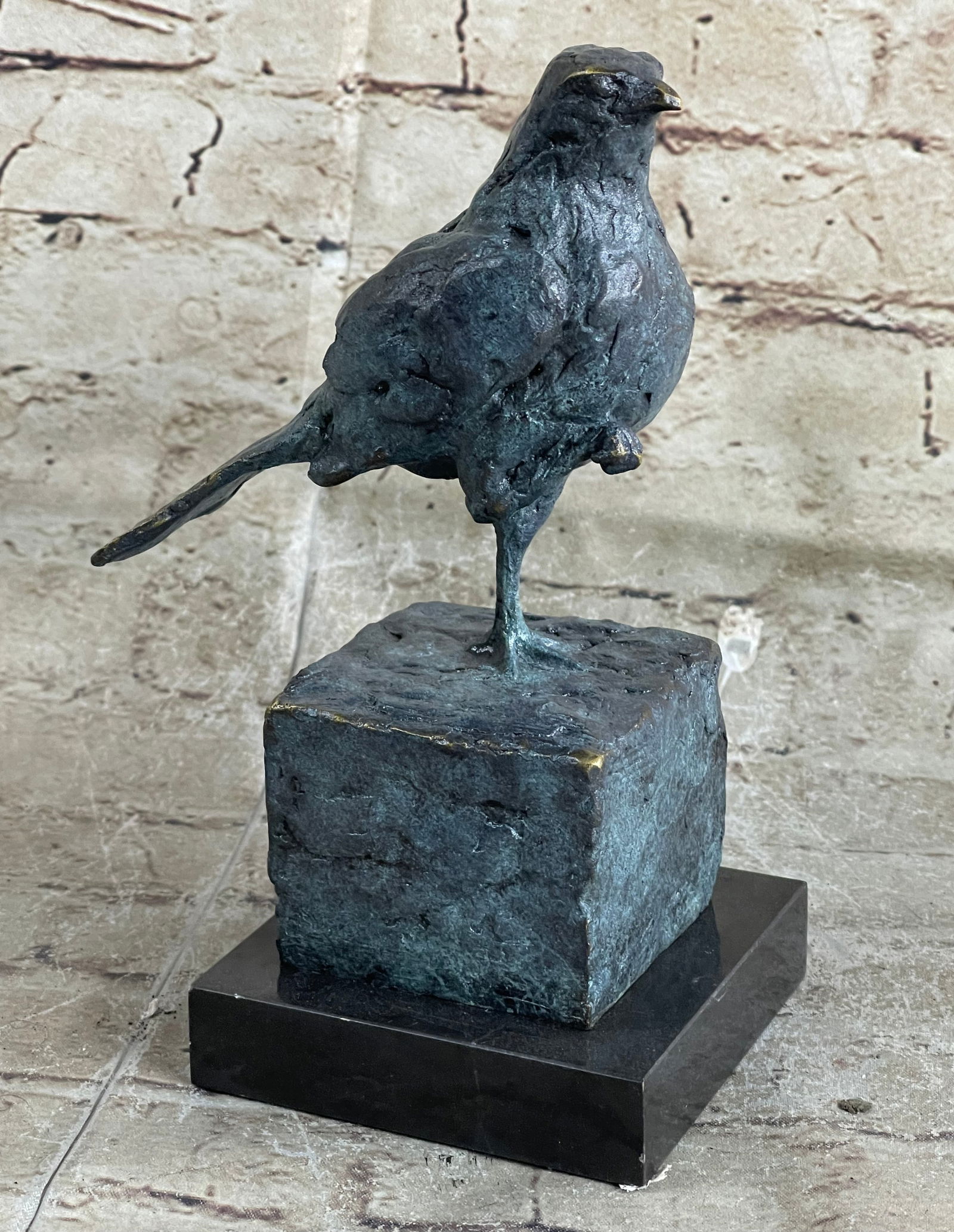 Bird Bronze Sculpture: As the lonely cute Sparrow stands on one leg, he looks around attentively for someone to save him. It s almost as if his one foot is stuck in the cement and he curls his other leg up to avoid it from