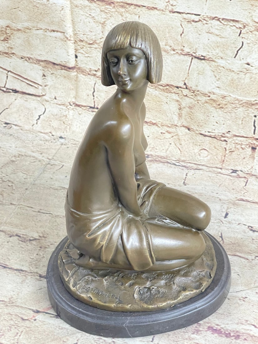 Shy Girl Bronze Sculpture: Young Girl in Thought A Classic Bronze Lost Wax Process Cire Perdue. This statue is mounted on a marble base. It depicts a young nude girl sitting in a pensive pose. Her crop cut hairstyle beautifully