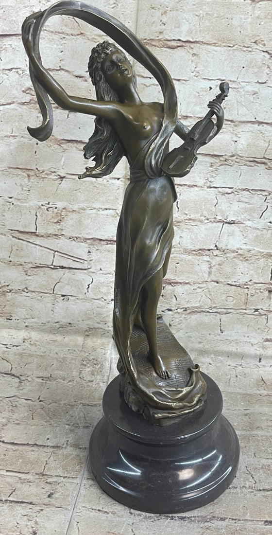 Lady Violinist Bronze Sculpture: A young woman finishes a powerful ballad on her violin. Her musical notes lift into the air that swirls around her, blowing her hair off her face. Her goddess dress drapes off her nude curves, exposin