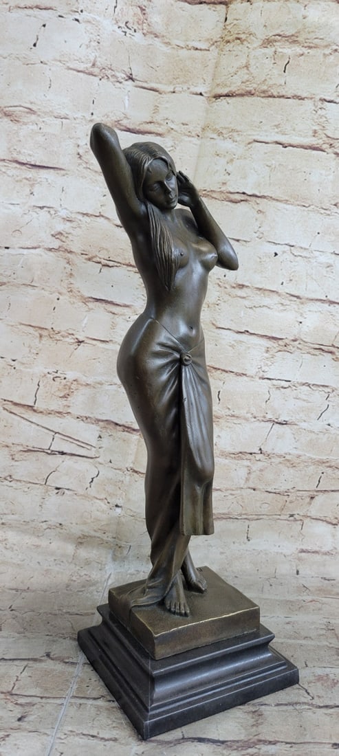 Nude Sexy Girl Bronze Sculpture: She stands in the warm sun and poses. She wears only a long skirt that is wrapped neatly around her curves and gathered in the center by a rosebud. This brown patina Sculpture was cast using the Lost