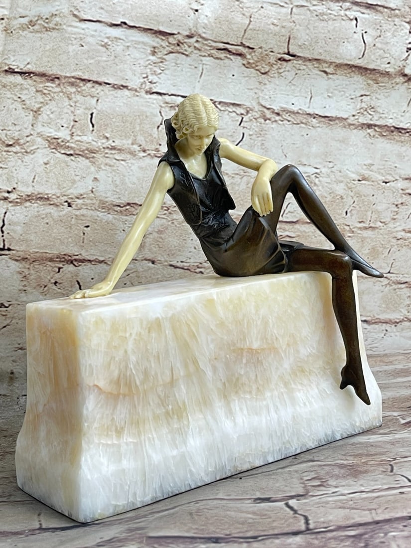 Nude Sexy Girl Sitting on Chair Bronze Sculpture: Sitting provocatively yet elegantly, a confident young woman reveals her long curvy legs in a short tight mini skirt to stir envy amongst other women and to provoke lust amongst men who indulge her be
