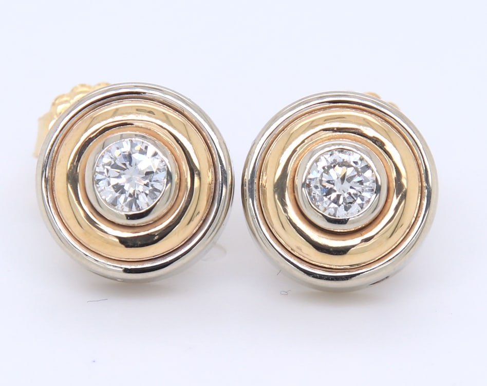 Attractive Two Tone Gold approximate 0.50ctw 2 Tone Bezel Set Diamond Earrings: Attractive 14kt Two Tone Gold approximate 0.50ctw 2 Tone Bezel Set Diamond Earrings. Total weight of the Earrings is 6.90 Grams.