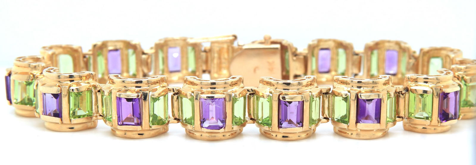 14kt Yellow gold peridot and amethyst link bracelet: 14kt Yellow gold peridot and amethyst link 8 inches bracelet. Total weight of bracelet 39.1 grams.