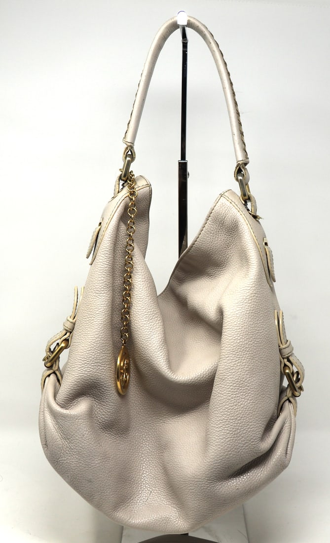 Bally off white leather shoulder bag: Bally off white leather shoulder bag with gold tone B charm. 11"x12"