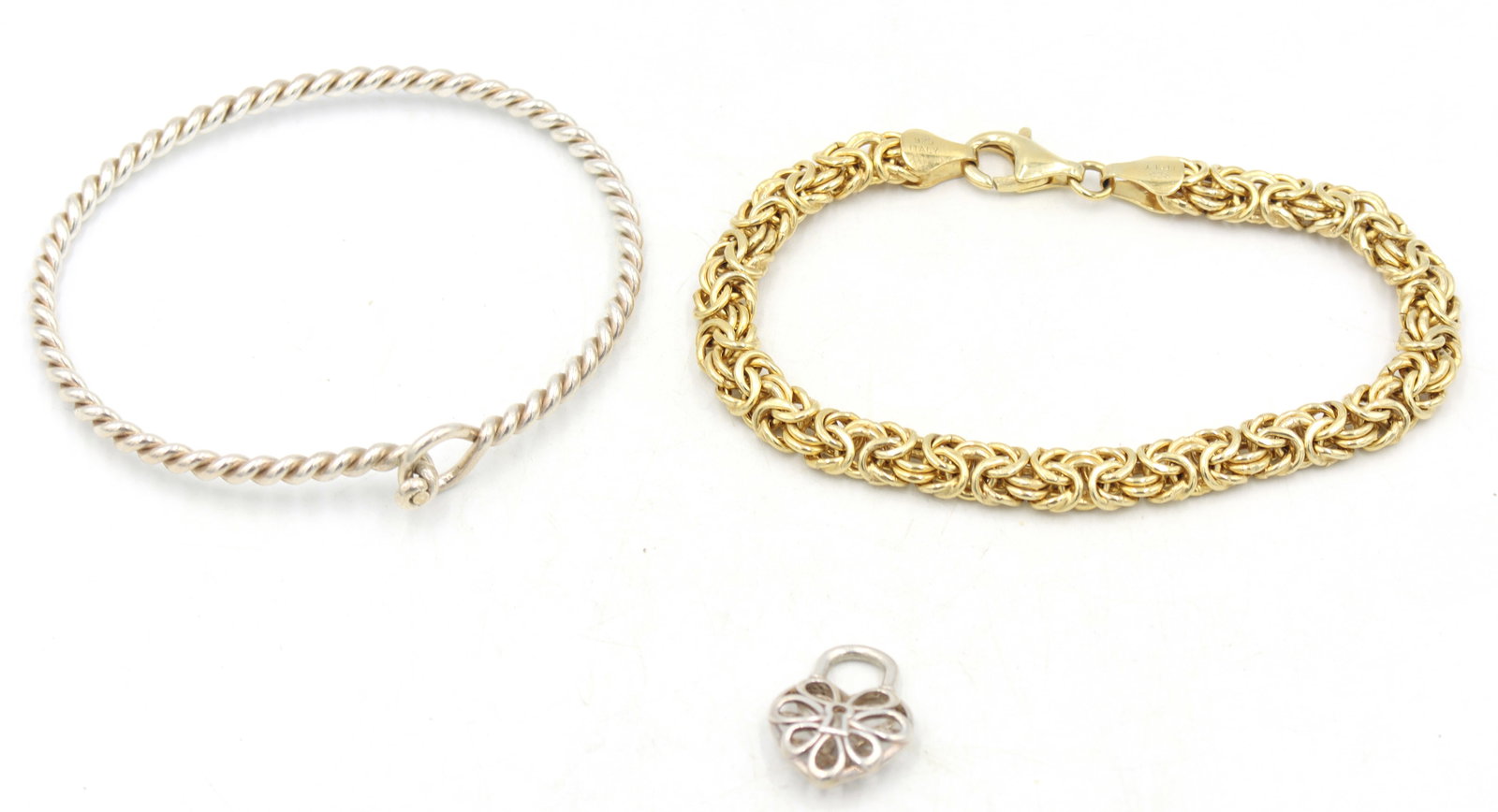 Group lot of Vintage 925 sterling silver Jewelry: Group lot of Vintage 925 sterling silver Jewelry. 2 Heart shaped pendants. Italian 7-inch Byzantine bracelet and twisted bangle. Total weight of lot is 21.7 grams.