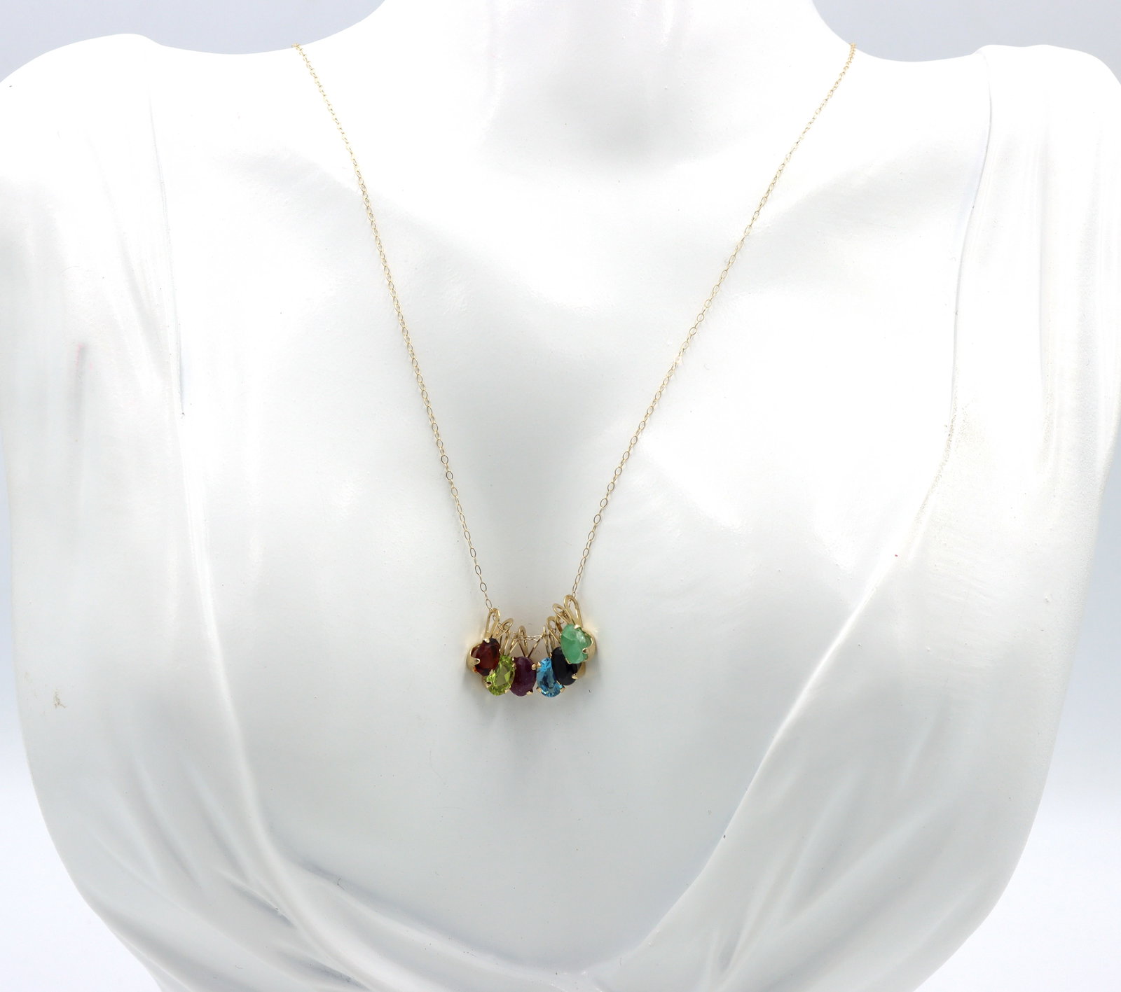 14kt Yellow gold multi color gemstone pendant on chain: 14kt Yellow gold multi color gemstone pendant on 18-inch chain necklace. The total weight of the necklace is 1.80 grams.