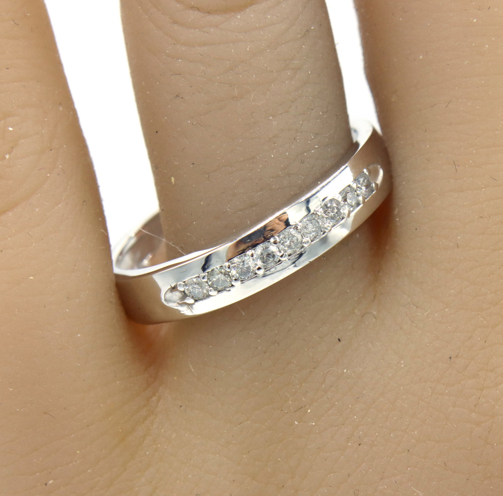 10kt White gold diamond accent band: Men's 10kt White gold diamond accent band. The total weight of the band is 3.15 grams. Ring size 11.5".