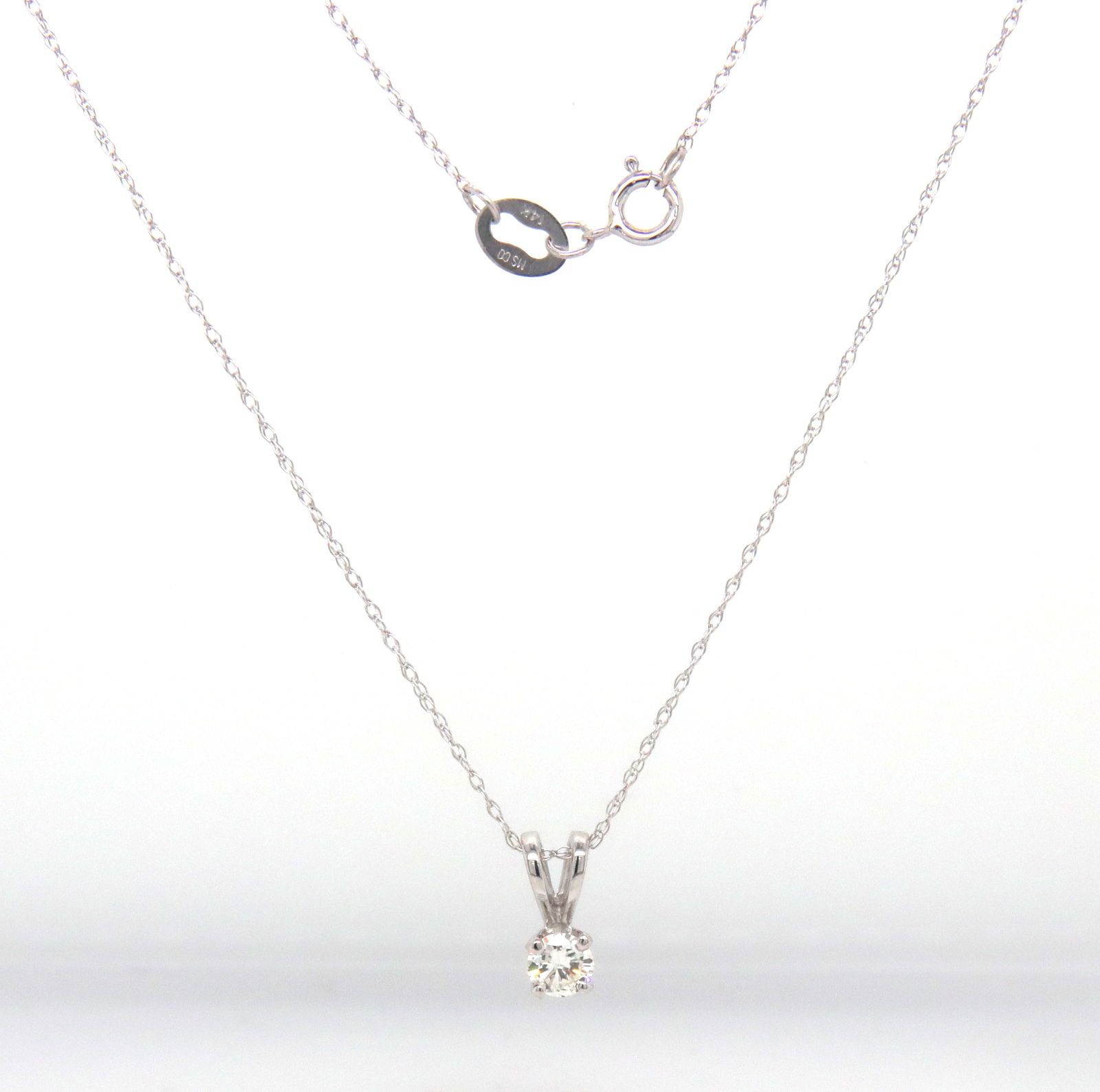 14kt White gold 0.15ctw round brilliant cut diamond pendant on chain: 14kt White gold approximate 0.15ctw round brilliant cut diamond pendant on 18-inch chain necklace with spring ring clasp. The total weight of the necklace is 0.90 grams.