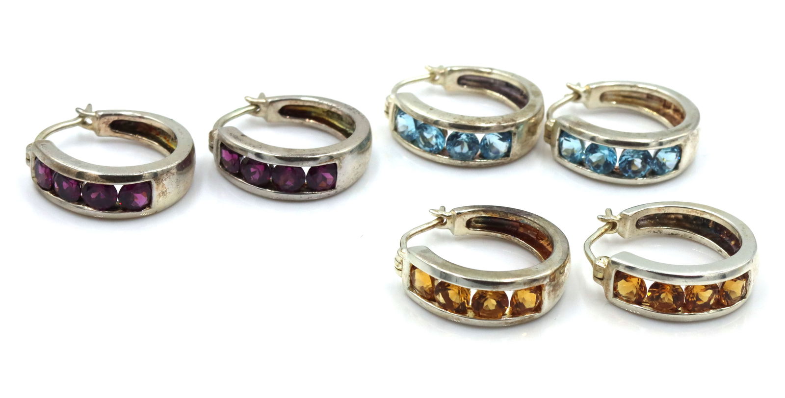 3 Pairs of 925 sterling silver cubic zirconia hoop earrings: 3 Pairs of 925 sterling silver cubic zirconia hoop earrings. The total weight of the lot is 18.5 grams.