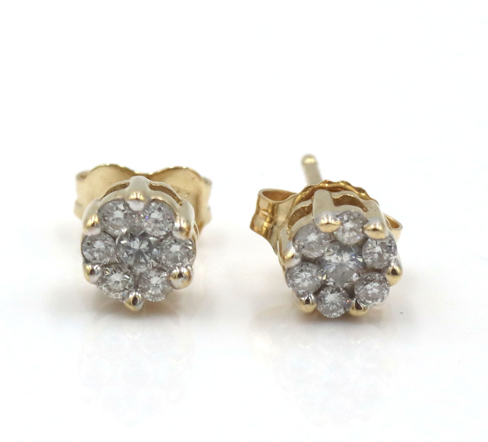 14kt Yellow gold 0.25ctw diamond cluster flower stud earrings: 14kt Yellow gold approximate 0.25ctw diamond cluster flower stud earrings. The total weight of the earrings is 1.5 grams.