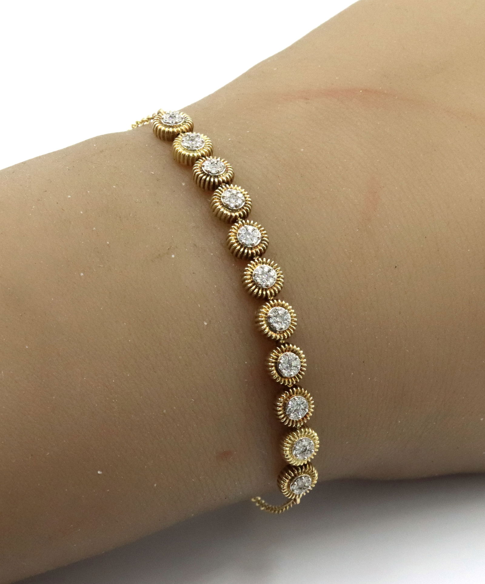 0.40ctw Round brilliant cut diamond cluster circle adjustable bracelet: 0.40ctw Round brilliant cut diamond cluster circle adjustable bracelet in 14kt Yellow gold. The total weight of the bracelet is 6.7 grams.