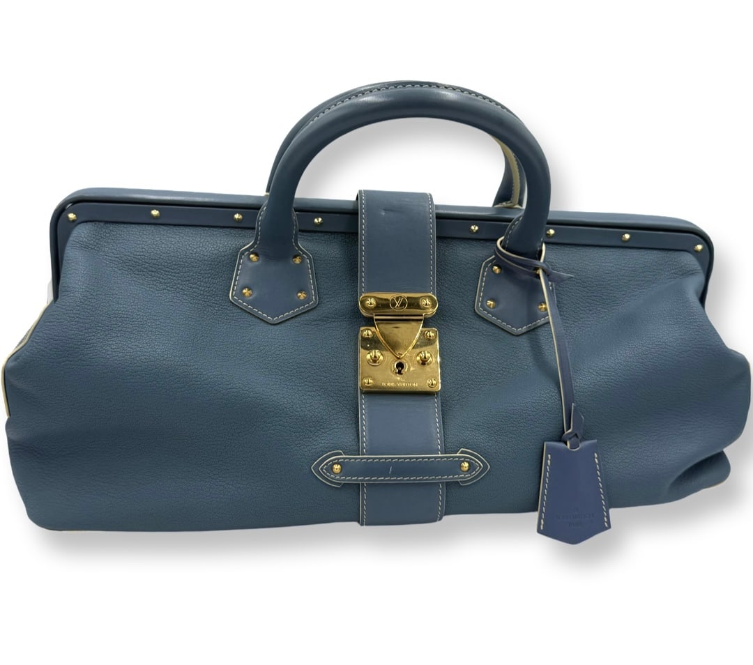Louis Vuitton Blue Suhali Leather L'Ingenieux GM Bag: Authentic Louis Vuitton Blue Suhali Leather L'Ingenieux GM top handle bag, Brass hardware and rolled handles and dual shoulder straps. Leather and studded accents. Dual exterior pockets. Logo