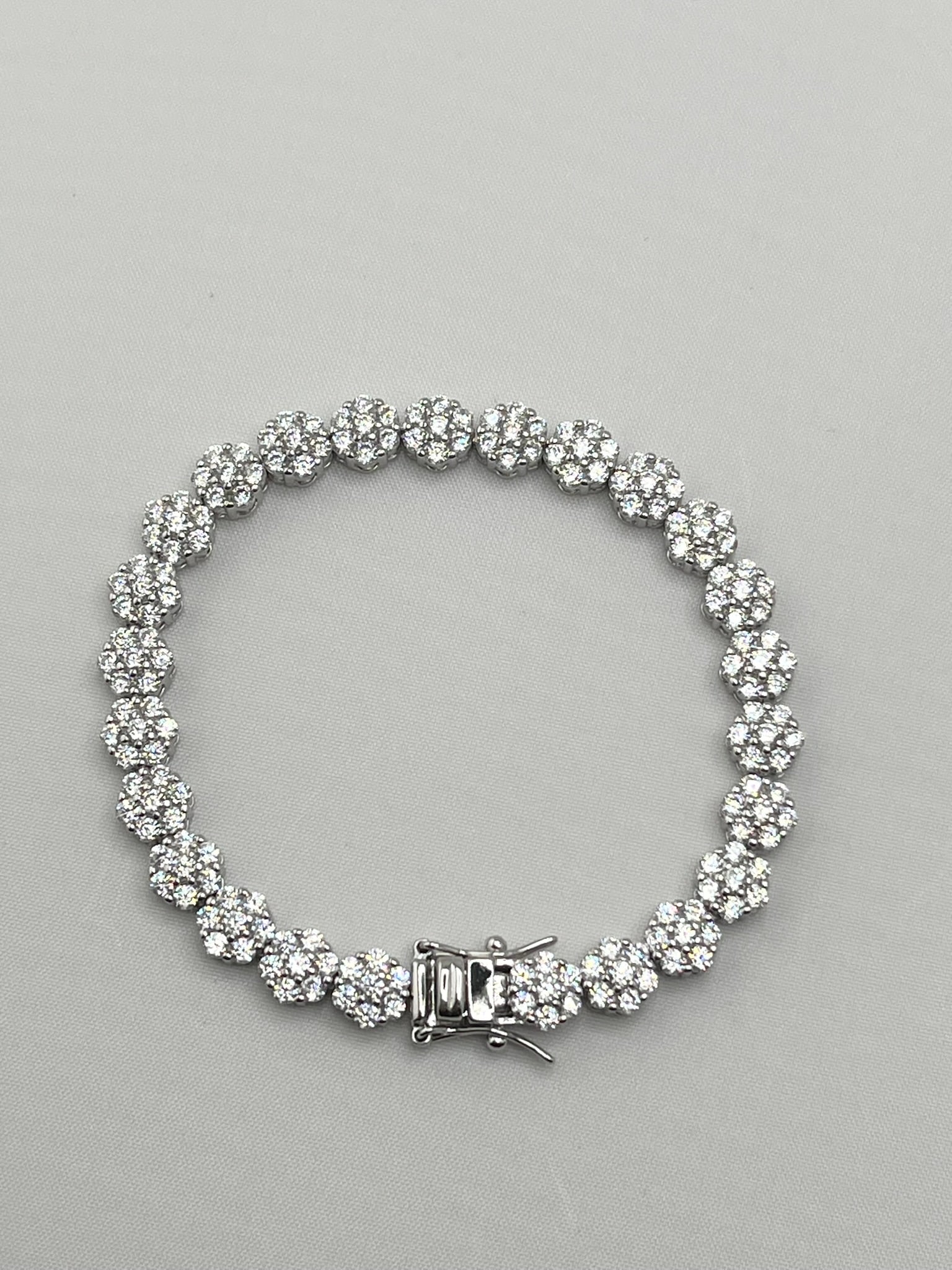 925 Sterling CZ Cluster Eternity Tennis Bracelet: 925 sterling silver cluster eternity tennis CZ bracelet with box clasp and safety latch. 14.1 grams, size 7 inches