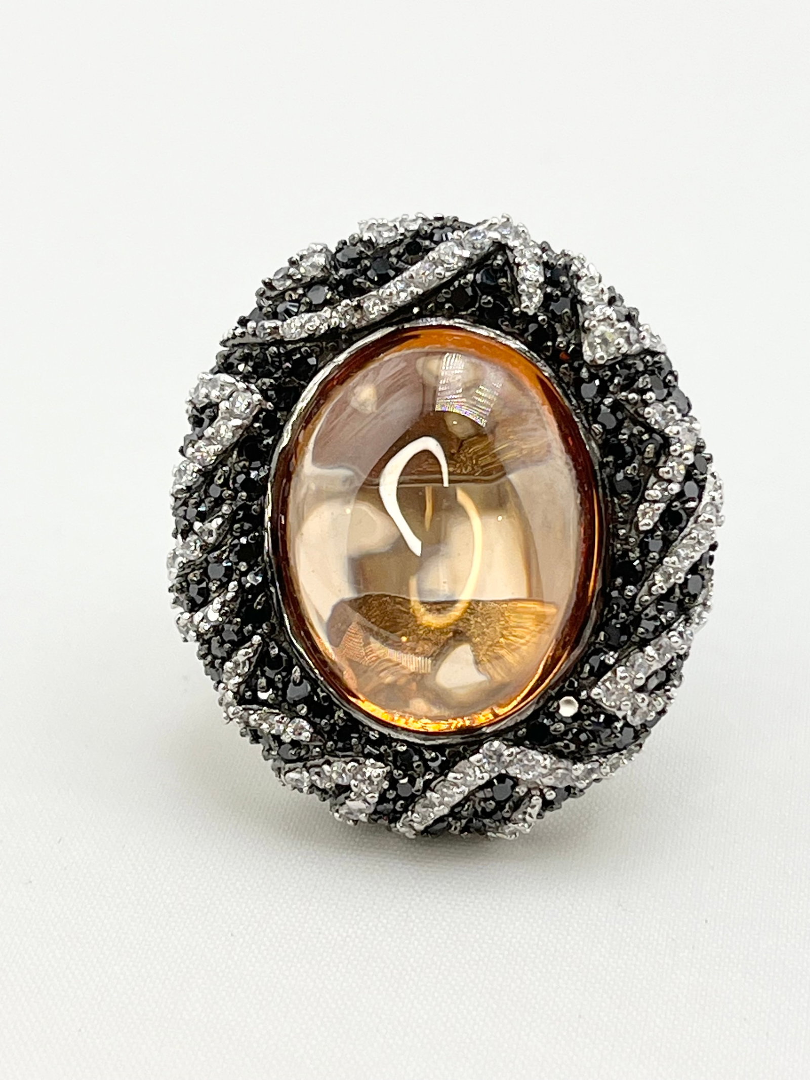 925 Sterling Silver Large Oval Amber Color Stone With Halo And Intricate Black and White Crystal Pav: 925 Sterling Silver Large Oval Amber Color Stone With Halo and intricate design, incorporating Black and White Crystal Pave Cocktail Statement Ring. 20.2 grams. size 6.3/4